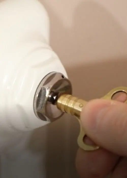 Entlüften eines Heizkörpers mit einem Heizungsschlüssel